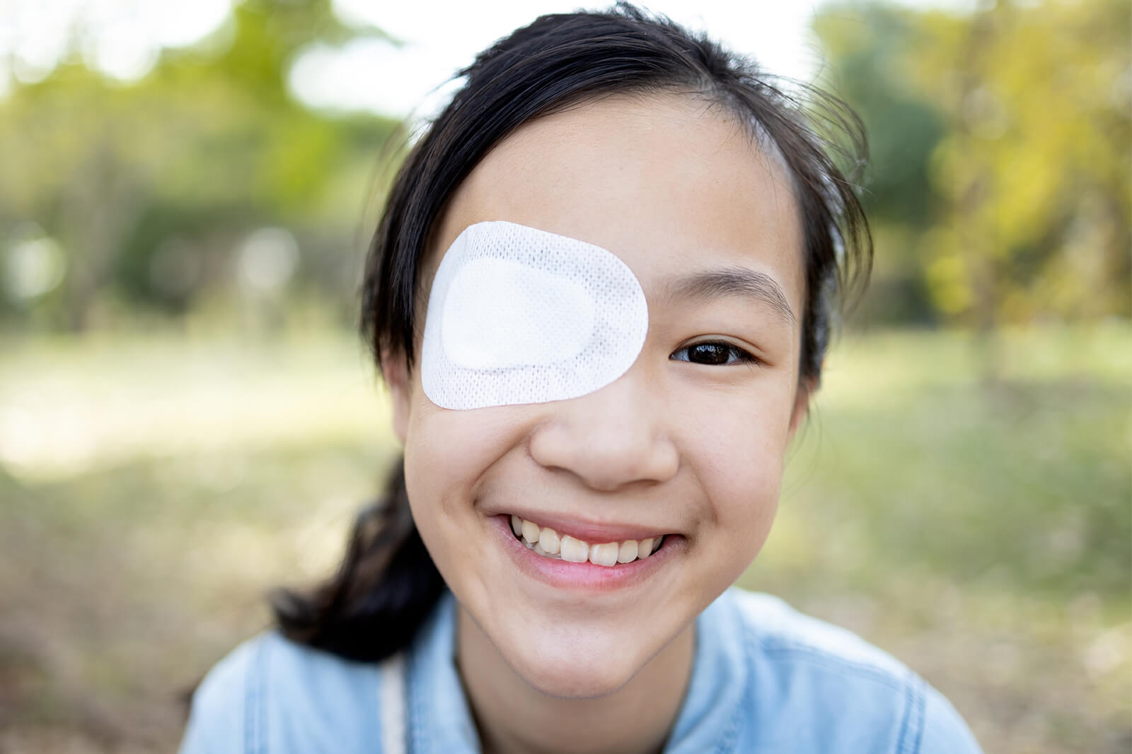 Smiling Child With an Eye Patch